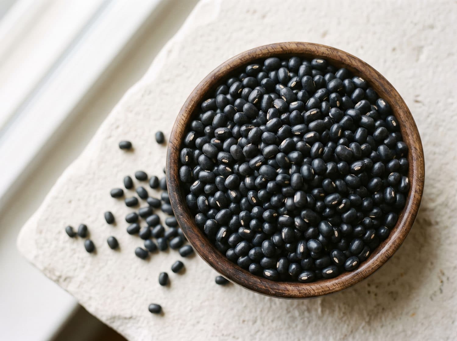 Whole black urad in a wooden bowl